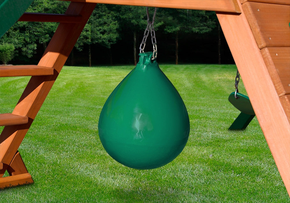 Lifestyle shot of green punching ball hanging from wooden playset.
