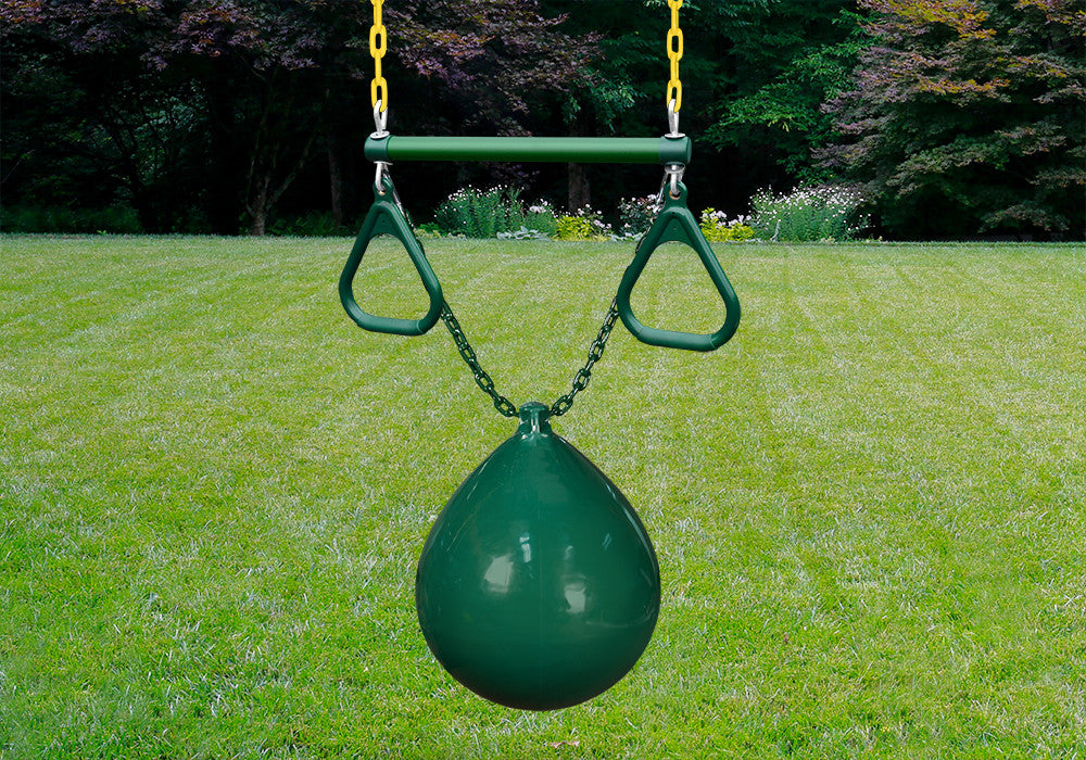 Lifestyle image of green buoy ball hanging from trapeze bar.