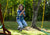 Outdoor shot of girl swinging on the Green Disc Swing from Gorilla Playsets