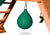 Green punching ball hanging from swing set.