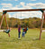 Lifestyle of kids playing on the Scout custom swing set