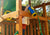 Girl holds the blue and yellow telescope with compass by Gorilla Playsets while standing on a playset deck.